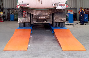 SITA Environmental truck on scissor lift before it begins being lifted