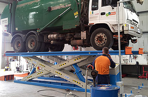 SITA Environmental truck on scissor lift in full rise position ready to be worked on