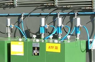 Lubrication tanks outside workshop pit showing pumps feeding into main high pressure lines