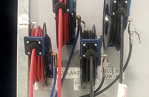 lubrication hose reels mounted on external building wall at entry to workshop facility