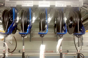 lubrication hose reels mounted inside suspended ceiling workshop pit, shows high press lines & systems